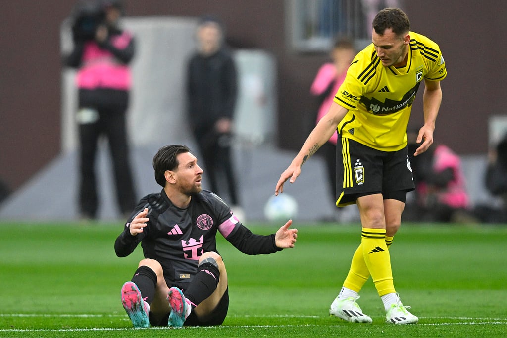 Daniel Gazdag, right, reaches out to Inter Miami CF forward Lionel Messi