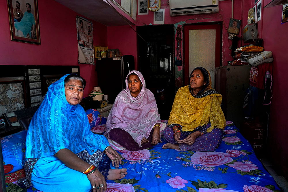 waqf act 2025: Qureshi Bano (L) sits in her 1R flat with at the Shia colony