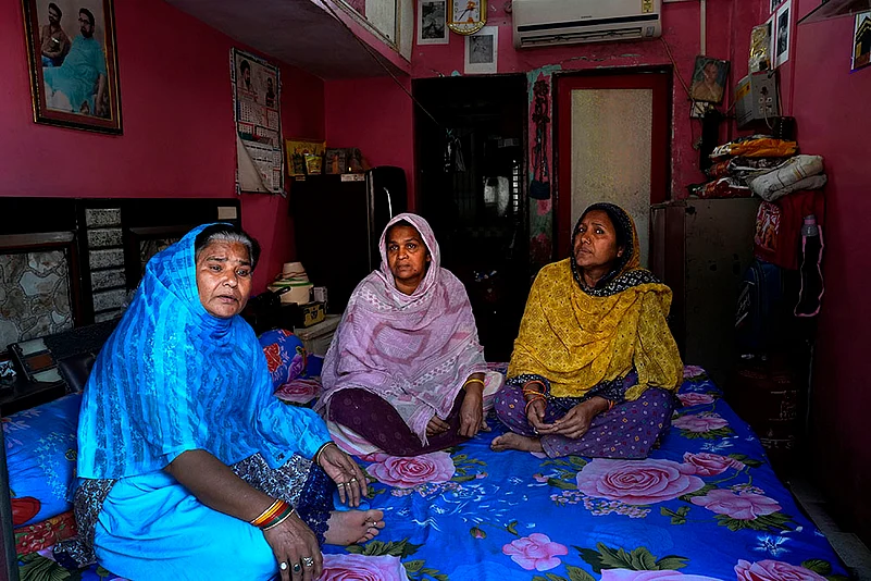 waqf act 2025: Qureshi Bano (L) sits in her 1R flat with at the Shia colony
