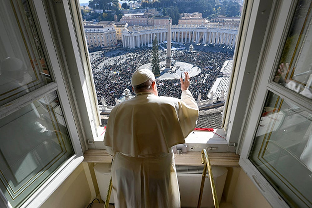Pope Francis waves  to the faithful gathered in St. Peters Square