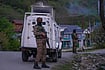 AP: Dar Yasin : Indian security officers stand guard on a highway in south Kashmir after assailants indiscriminately opened fired at tourists in Pahalgam
