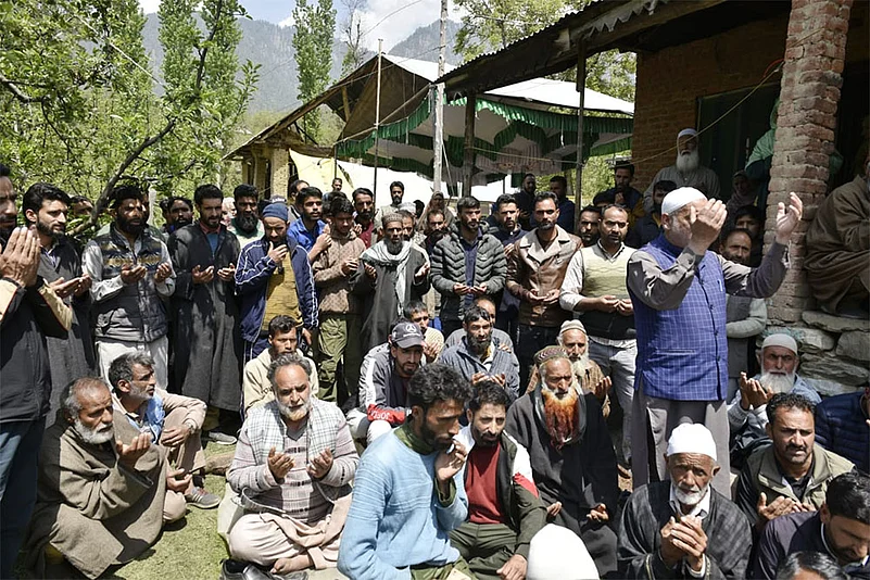 Local villagers and relatives praying for the deceased