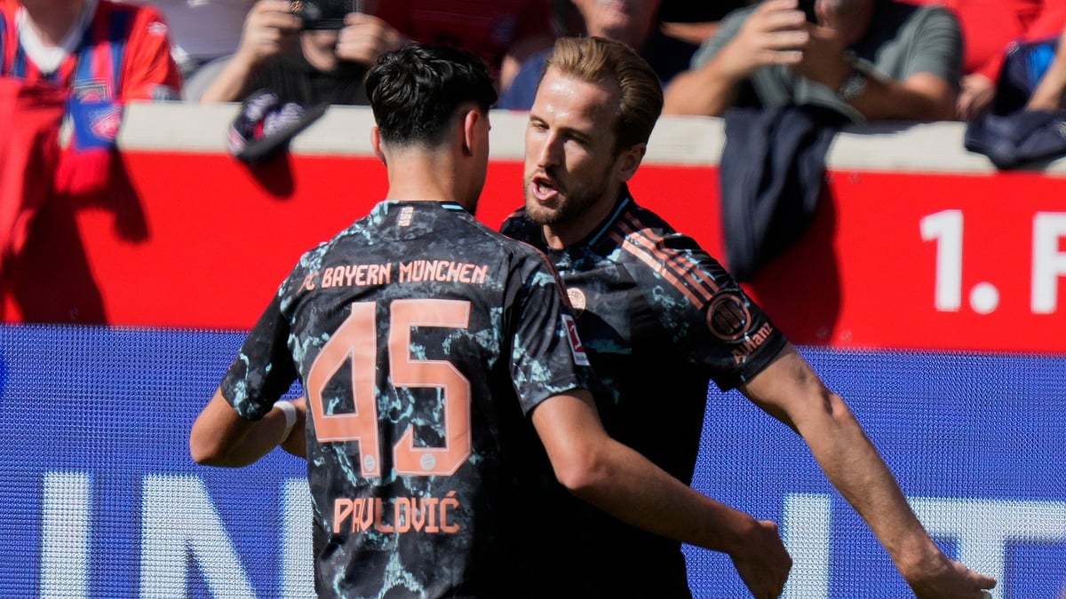 Bayern Munich's Aleksandar Pavlovic and Harry Kane celebrate a goal during their German Bundesliga 2024-25 match against Heidenheim in Heidenheim on April 19, 2025. - AP/Matthias Schrader