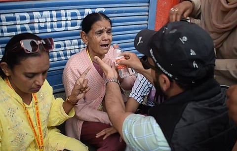 A local Kashmiri man consoles Kanda Behen, a tourist from Gujarat, who breaks down in tears following the Pahalgam attack that killed 25 tourists and one local, on April 23, 2025 |
