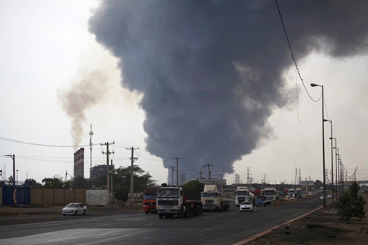 Mohammad Rasoul Moradi/IRNA via AP : In this photo provided by Islamic Republic News Agency, IRNA, a black smoke rises in the sky as vehicles drive on the road after a massive explosion near the southern port city of Bandar Abbas, Iran, Saturday, April 26, 2025.