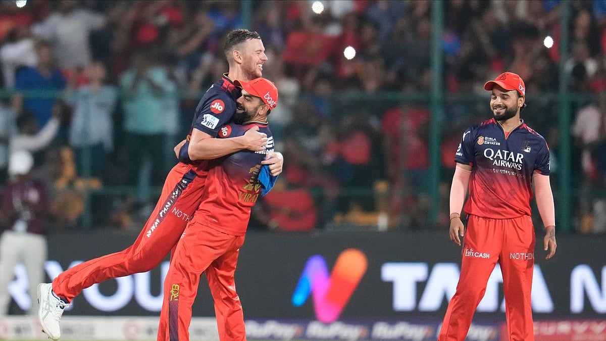 AP Photo/Aijaz Rahi : Royal Challengers Bengaluru's Josh Hazlewood, left, celebrates with teammate Virat Kohli after their win in the Indian Premier League cricket match against Rajasthan Royals at Chinnaswamy Stadium in Bengaluru.
