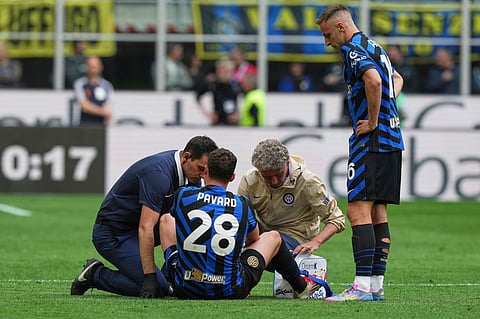 Inter Milan's Benjamin Pavard, bottom, receives medical treatment during the Serie A soccer match between Inter Milan and Roma at the San Siro Stadium, in Milan, Italy, Sunday, April 27, 2025. 


