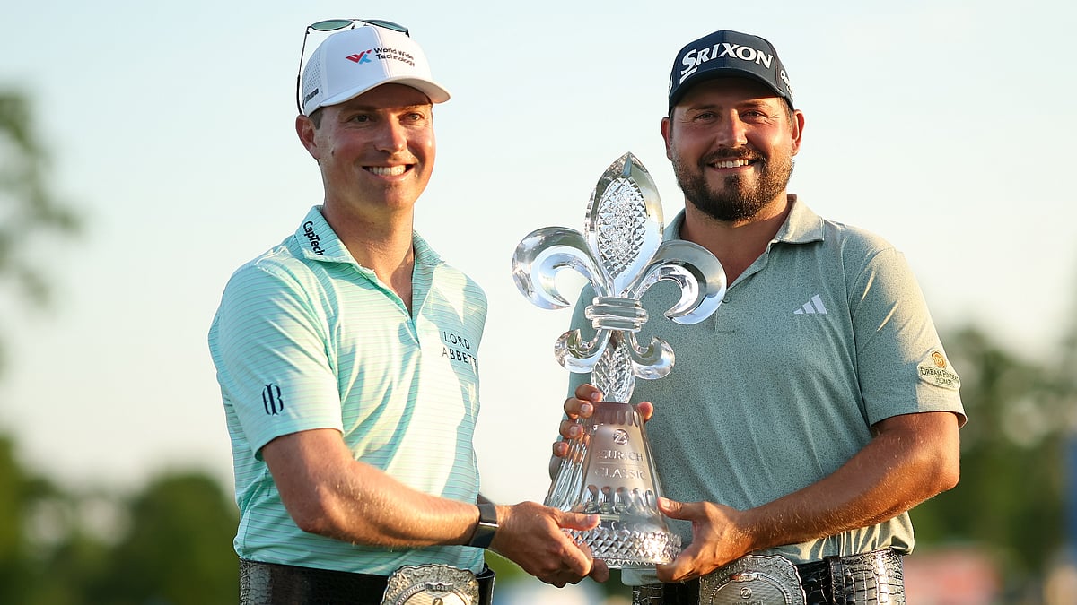 Ben Griffin and Andrew Novak pose with the Zurich Classic of New Orleans trophy.