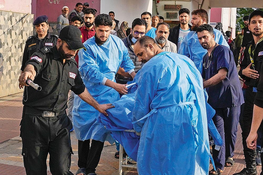 Shattered Peace: Paramedics carry a wounded man to a hospital in Anantnag after the terrorist attack