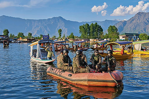 On Alert: Paramilitary soldiers patrol the Dal Lake in Srinagar
