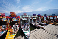 Pahalgam Attack: Striking at Kashmir's Livelihood | Photo: AP : In Solidarity: Kashmiri boatmen hold placards to condemn the Pahalgam terror attack in Dal Lake, Srinagar