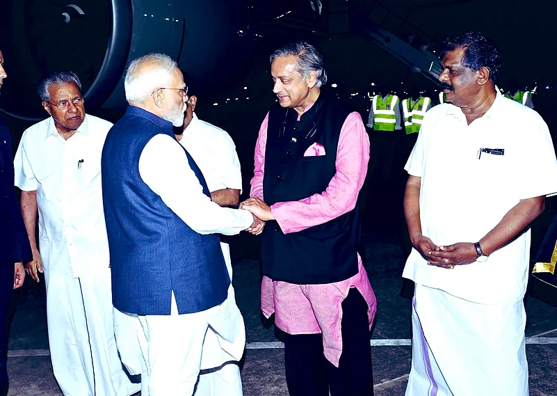 Congress MP Shashi Tharoor receives PM Modi in Kerala
