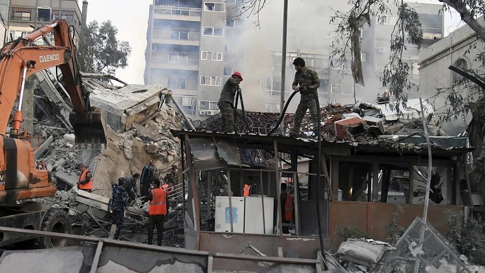 AP : The workers clear the rubble at a destroyed building struck by Israeli jets in Damascus, Syria | Representational Image