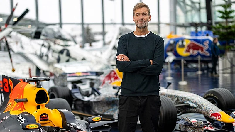 Jurgen Klopp Poses With Red Bull F1 cars in Salzburg