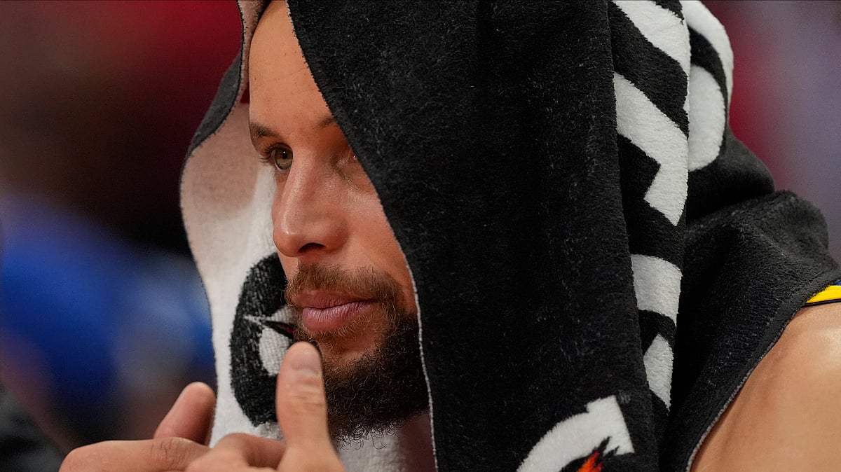 Golden State Warriors guard Stephen Curry watches from the bench during the second half of Game 5 of an NBA basketball first-round playoff series against the Houston Rockets, Wednesday, April 30, 2025, in Houston.  - (AP Photo/David J. Phillip)

