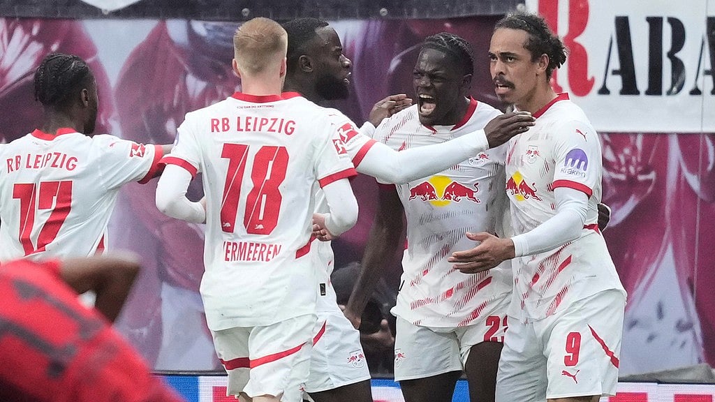 Photo: AP : Leipzig's Yussuf Poulsen, right, celebrates with teammates after scoring his side's third goal during the German Bundesliga match against FC Bayern Munich. 
