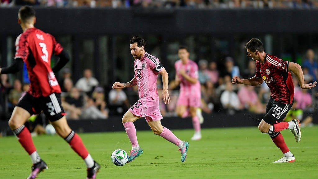 AP/Michael Laughlin : Inter Miami forward Lionel Messi dribbles the ball against New York Red Bulls defenders Noah Eile (3) and Sean Nealis (15) during the first half of an MLS soccer match, Saturday, May 3, 2025, in Fort Lauderdale, Fla.