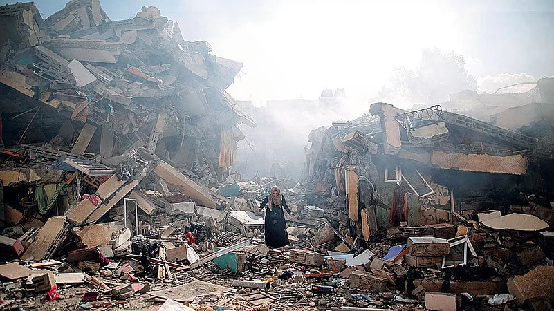 A resident walks through the rubble of residential buildings after Israeli air-strikes in Gaza Strip