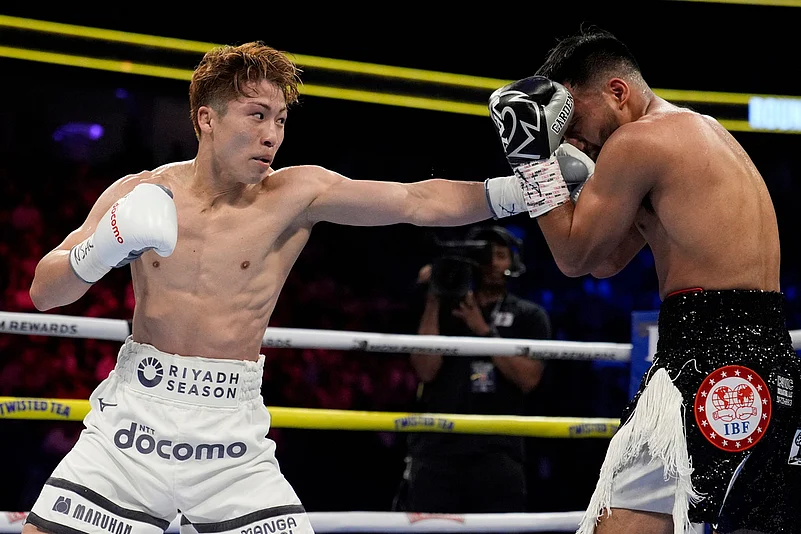 Naoya Inoue hits Ramon Cardenas in a junior featherweight title boxing match Sunday
