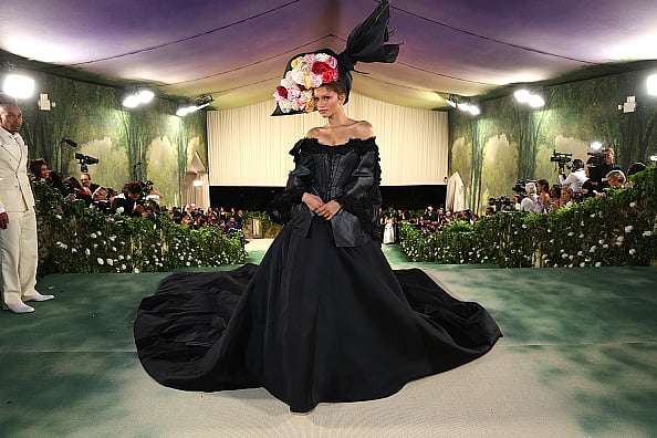 Zendaya in a floral headpiece and black vintage gown by John Galliano at Met Gala 2024