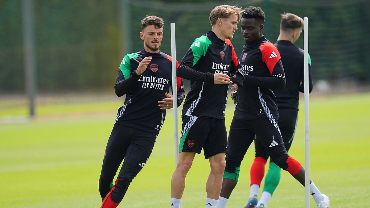 Arsenals Ben White, left, Arsenals Martin Odegaard, centre. AP