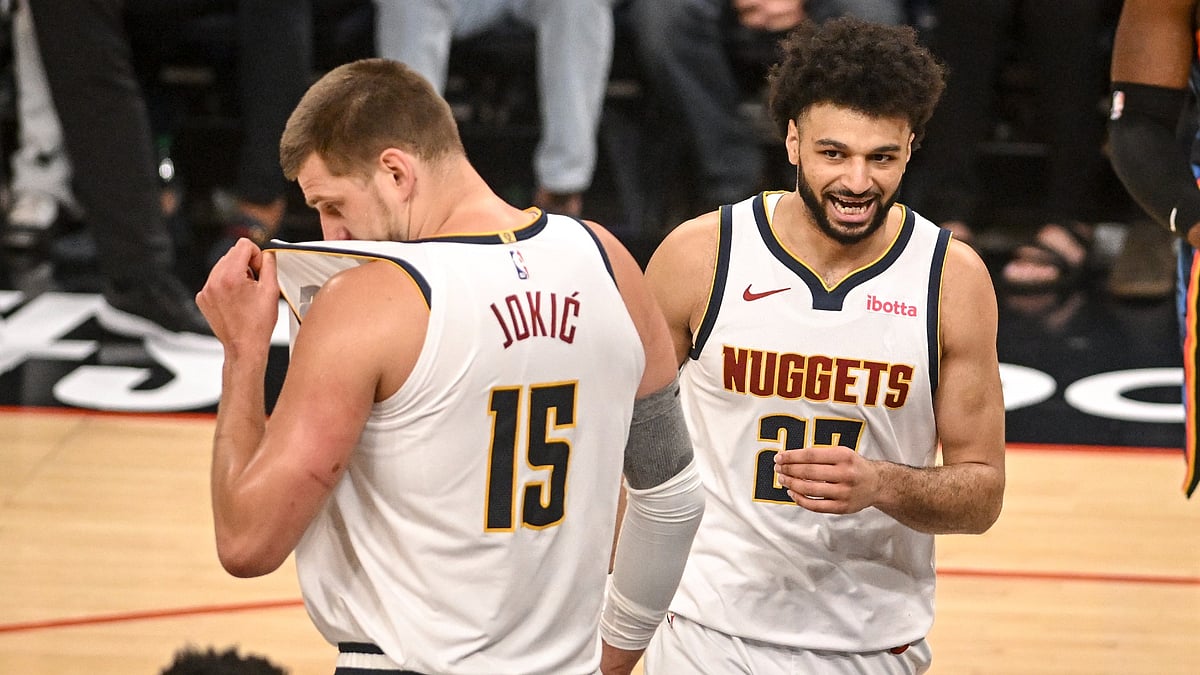 Nikola Jokic and Jamal Murray of the Denver Nuggets stand on the court vs. the Oklahoma City Thunder on May 5, 2025.