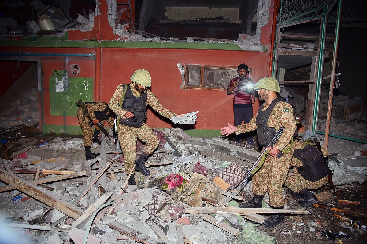 Army soldiers inspect a building damaged by a suspected Indian missile attack near Muzaffarabad, PoK - AP Photo/M.D. Mughal