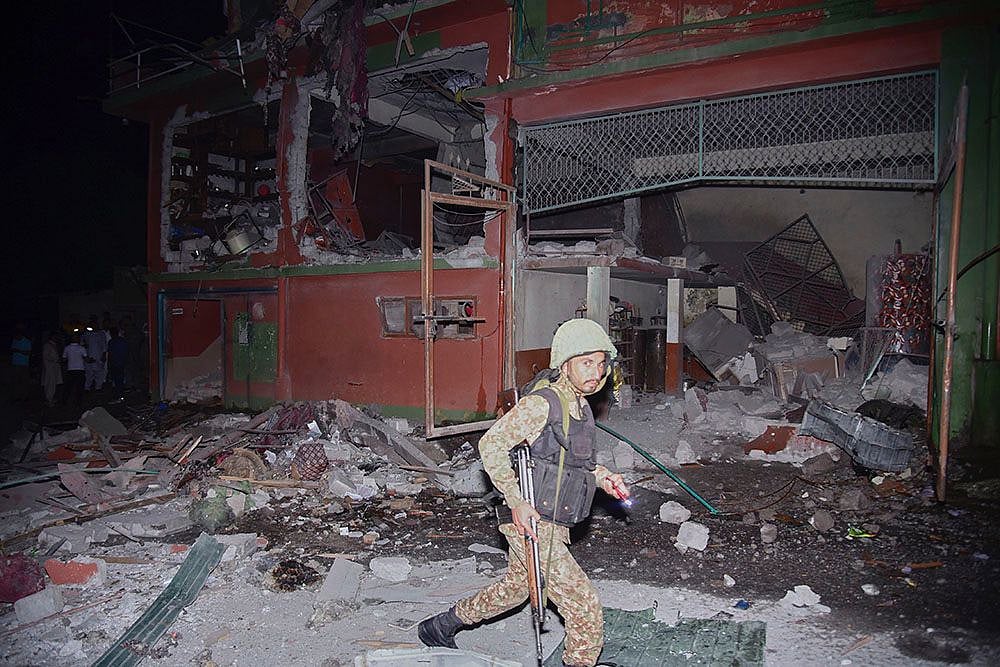 Army soldiers inspect a building damaged by a suspected Indian missile attack near Muzaffarabad, the capital of Pakistan controlled Kashmir, Wednesday, May 7, 2025.  - AP Photo/M.D. Mughal