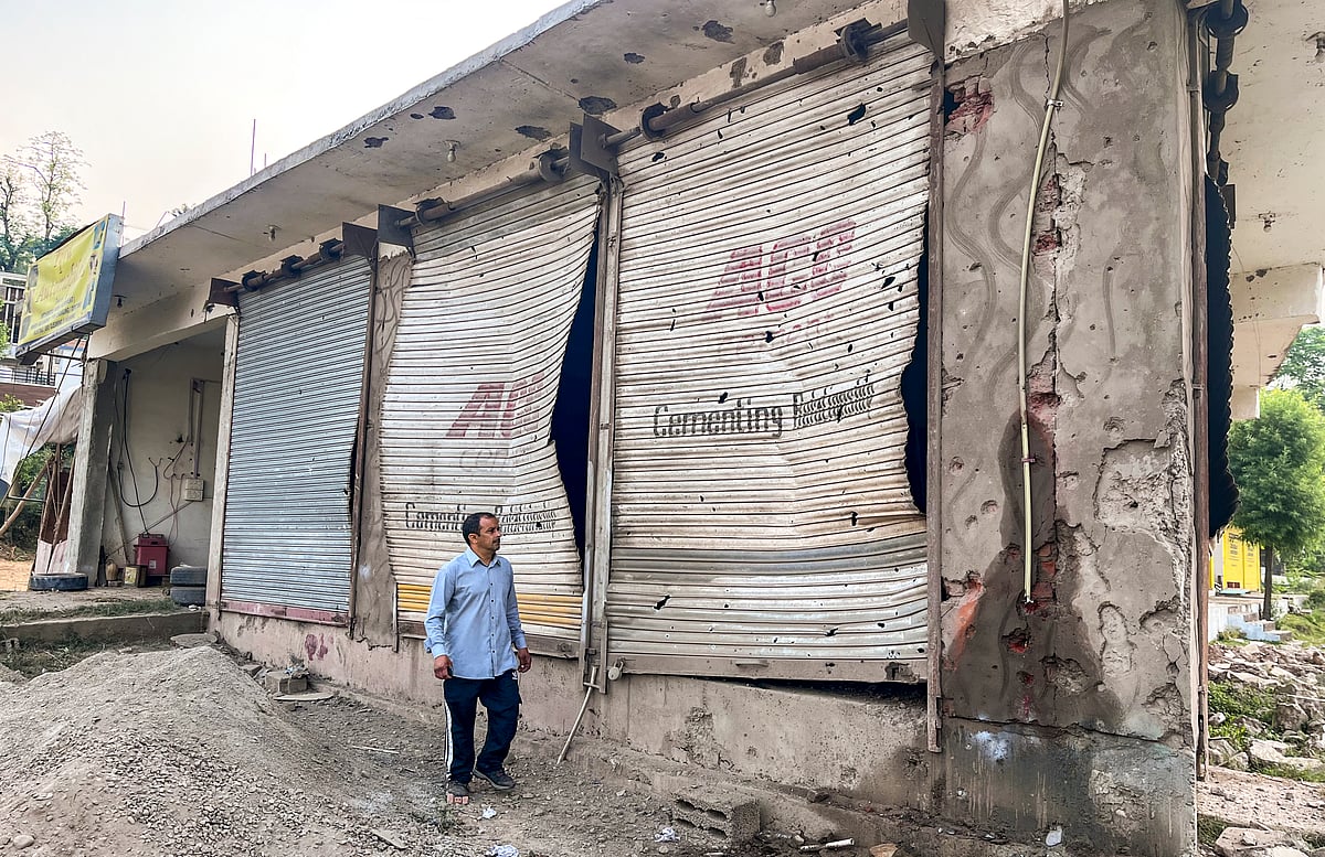 Poonch: A civilian looks at damaged properties after heavy firing and shelling by Pakistan military overnight across the Line of Control and International Border, at Mendhar area of Poonch district, Jammu and Kashmir, Wednesday, May 7, 2025. At least three civilians were killed and ten injured in the incident, according to officials.  - PTI