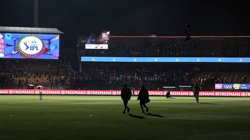 Workers leave the ground after the authorities asked to evacuate the stadium during the Indian Premier League cricket match between Punjab Kings and Delhi Capitals at Himachal Pradesh Cricket Association Stadium in Dharamshala, India, Thursday, May 8, 2025. - AP/Ashwini Bhatia