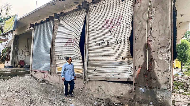 A civilian looks at damaged properties