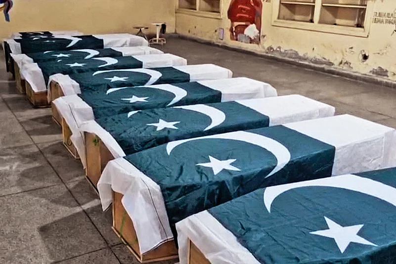 Caskets wrapped in Pakistani flags are placed for funeral services in Bahawalpur