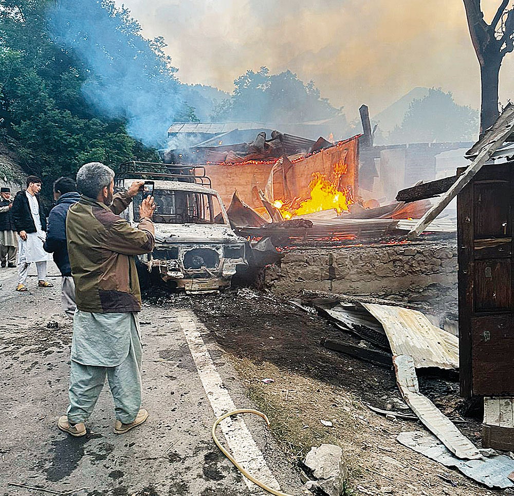 A house on fire at Hajinar as a result of shelling along the Line of Control (LoC)