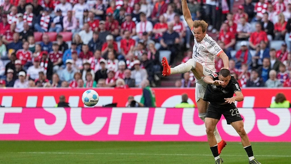 | Photo: AP/Matthias Schrader : Bayern Munich's Harry Kane challenges for the ball with Borussia Monchengladbach's Stefan Lainer during the German Bundesliga match.