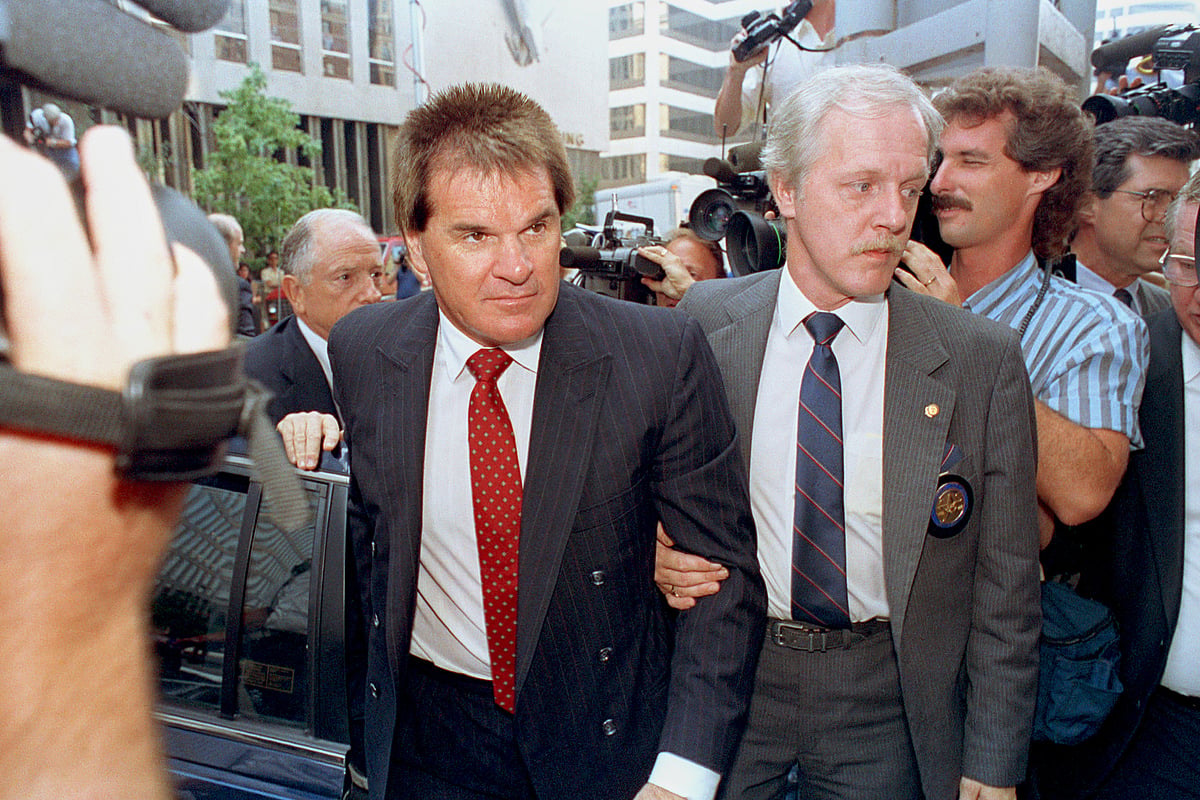 (AP Photo/Mark Lyons, File) : FILE - Former Cincinnati Reds manager Pete Rose is escorted by a Federal Marshal, right, as he arrives at federal court in Cincinnati, Ohio on July 19, 1990.