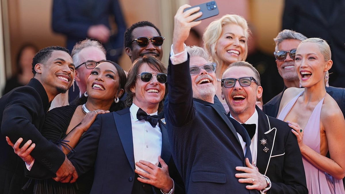 (Photo by Scott A Garfitt/Invision/AP) : Greg Tarzan Davis, from left, editor Eddie Hamilton, Angela Bassett, Tramell Tillman, Tom Cruise, director Christopher McQuarrie, Hannah Waddingham, Simon Pegg, Esai Morales, and Pom Klementieff take a selfie upon arrival at the premiere of the film 'Mission: Impossible - The Final Reckoning' at the 78th international film festival, Cannes, southern France, Wednesday, May 14, 2025.