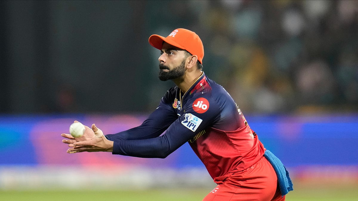 AP Photo/Aijaz Rahi : Royal Challengers Bengaluru's Virat Kohli catches the ball before passing it on to the bowler during the Indian Premier League cricket match between Royal Challengers Bengaluru and Chennai Super Kings at Chinnaswamy Stadium in Bengaluru.