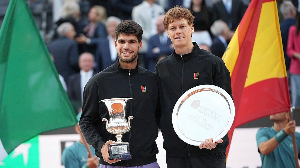 Photo: AP : Spain's Carlos Alcaraz, left, and Jannik Sinner of Italy pose with the silverware after the former won the Italian Open final in Rome.