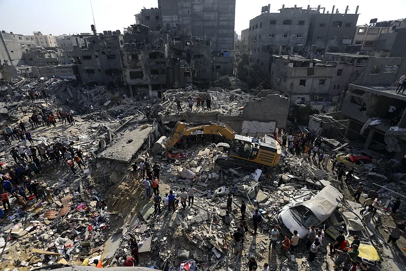 Palestinians looking for survivors under the rubbles after Israeli air strikes destroyed buildings