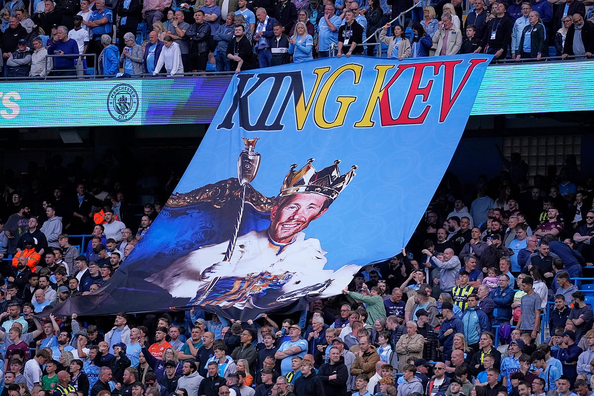 Manchester City fans hold up a Kevin De Bruyne tifo prior to the English Premier League soccer match between Manchester City and Bournemouth at the Etihad stadium in Manchester, England, Tuesday, May 20, 2025.


