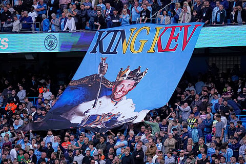 Manchester City fans hold up a Kevin De Bruyne tifo prior to the English Premier League soccer match between Manchester City and Bournemouth at the Etihad stadium in Manchester, England, Tuesday, May 20, 2025.

