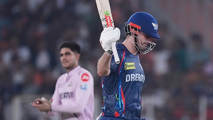 Mitchell Marsh raises his bat.