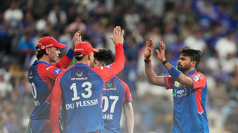 Delhi Capitals Mukesh Kumar, right, celebrates with teammates. AP