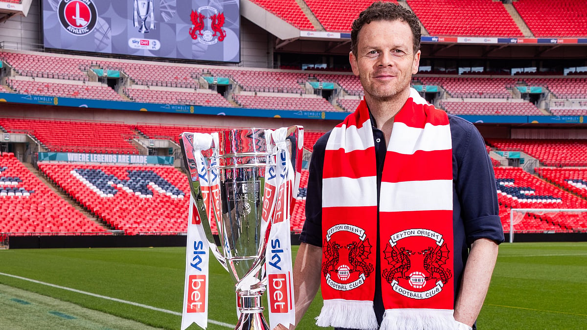 | Photo: leytonorientfc : Former Leyton Orient player Matt Lockwood poses with the EFL League One 2024-25 playoff trophy before the match against Charlton Athletic.