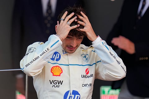 Ferrari driver Charles Leclerc of Monaco reacts on the podium after placing second at the Formula One Monaco Grand Prix race at the Monaco racetrack in Monaco, Sunday, May 25, 2025. 
