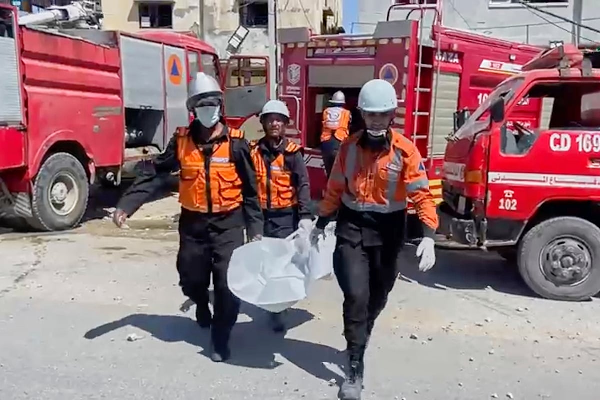 Gaza Civil Defense via AP : In this frame grab from a video released by Gaza Civil Defense, workers collect human remains after an Israeli strike on a home in Khan Younis killed nine of a doctor's ten children while she was at work, according to Ahmad al-Farra, head of the pediatric department at Nasser Hospital, in Khan Younis, Gaza Strip, Saturday, May 24, 2025. 