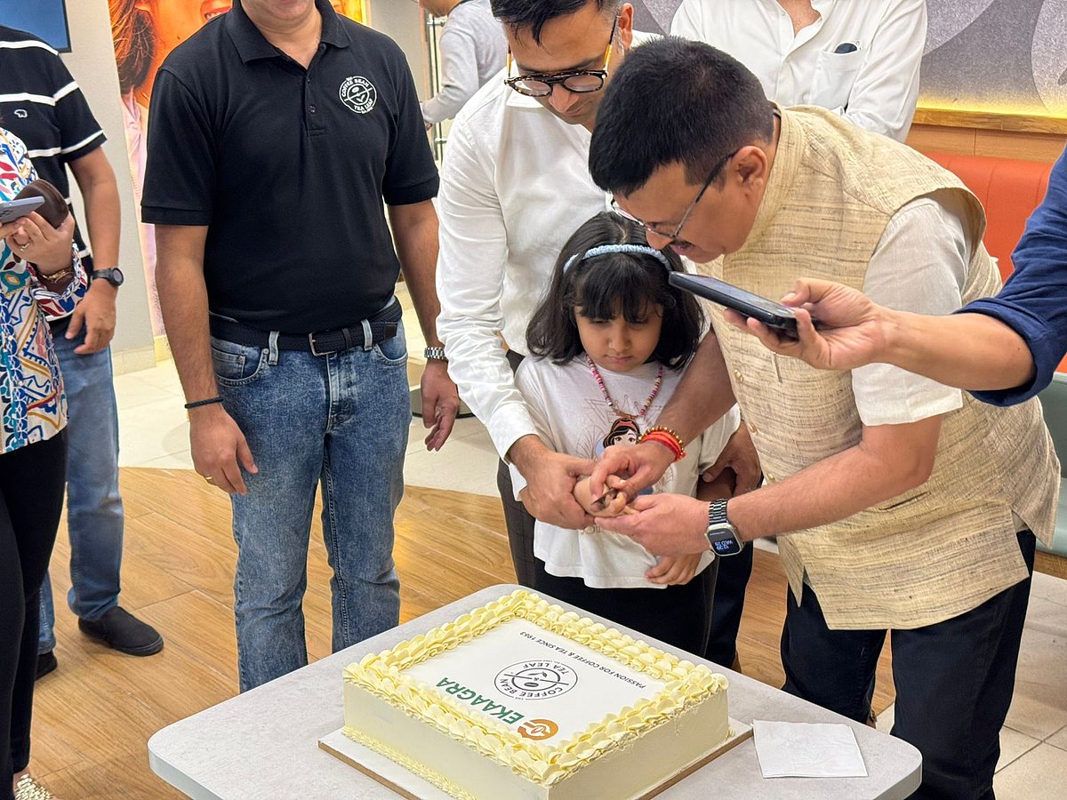 Mr. Satendra Singh and a little girl cutting the cake