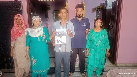 Sahil's family holding his picture