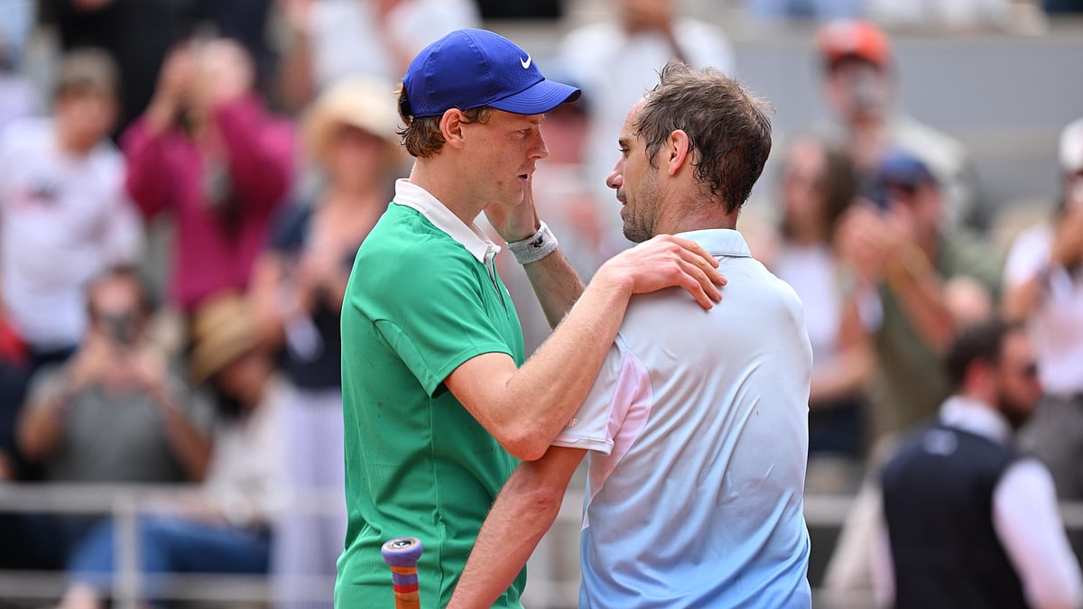 Jannik Sinner at the net with Richard Gasquet