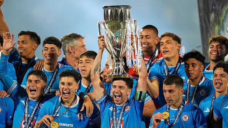 Ignacio Rivero of Mexico's Cruz Azul lifts the trophy after winning the CONCACAF Champions Cup final soccer match against Canada's Vancouver Whitecaps in Mexico City, Sunday, June 1, 2025. - (AP Photo/Fernando Llano)